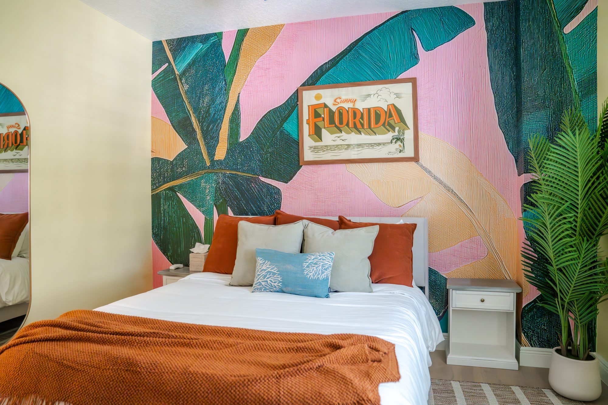 Bedroom 3 with queen bed, pink banana leaf mural and Sunny Florida print