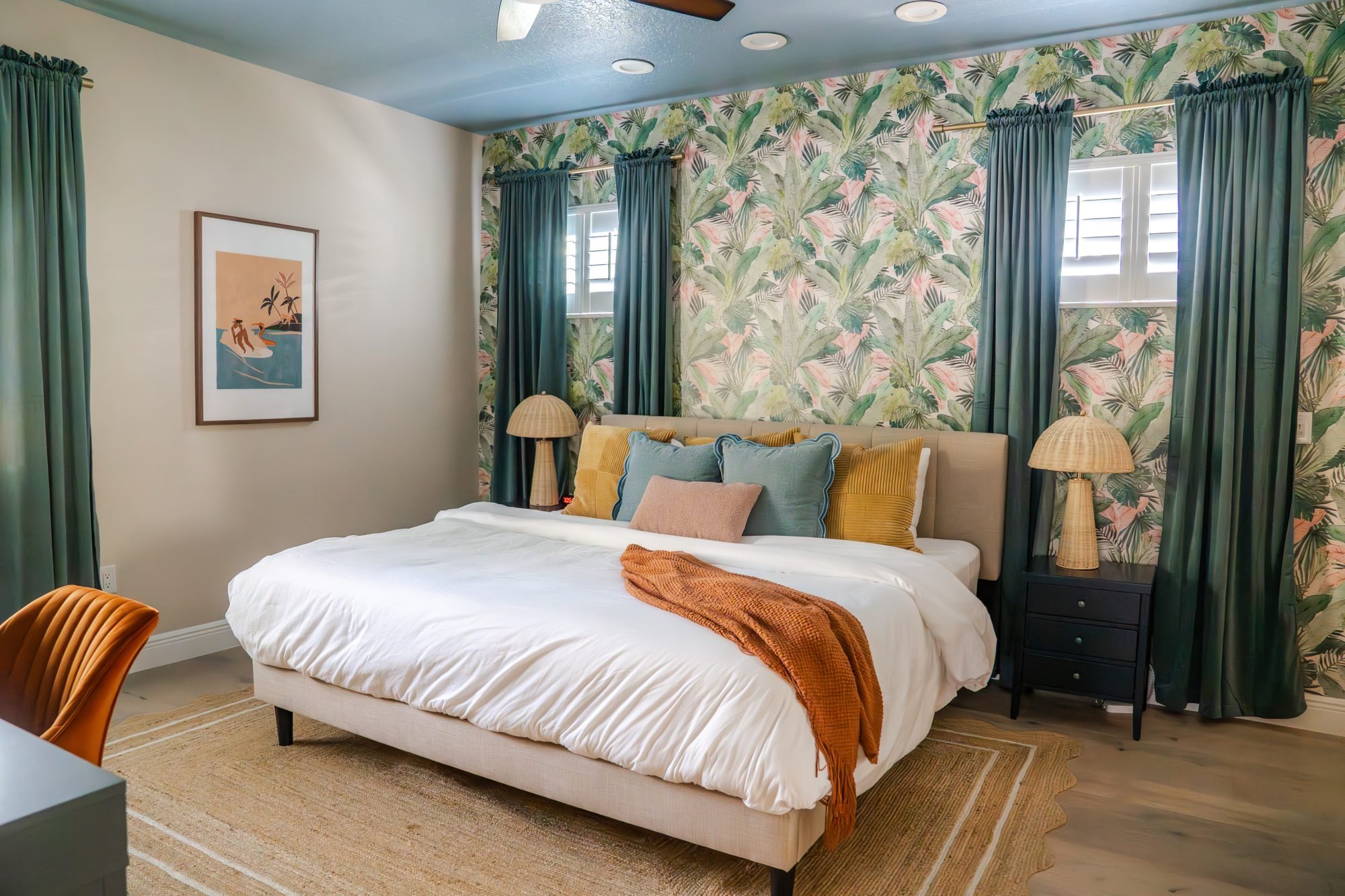 Bedroom 1 with king bed, tropical wallpaper and green velvet curtains