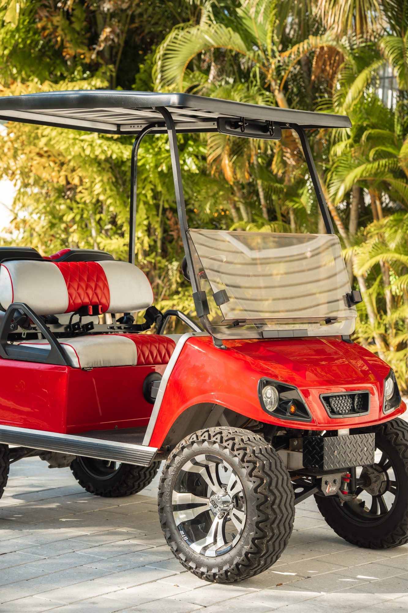 Free red 4-person golf cart under the palm trees